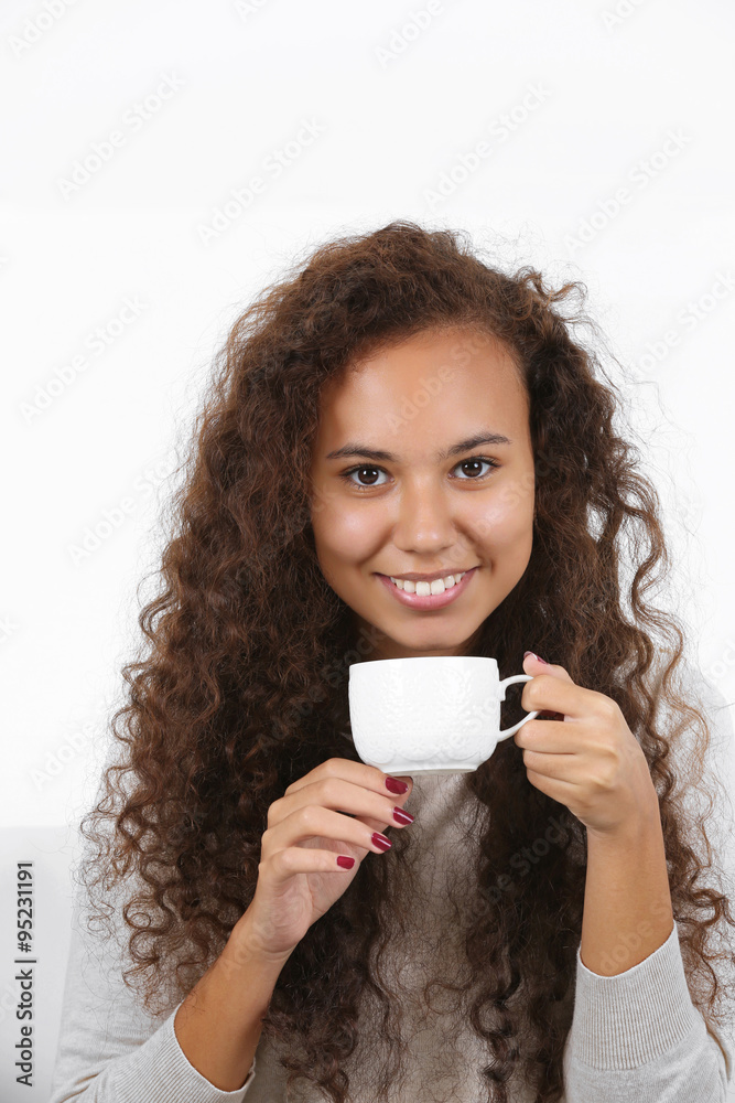 Close up portrait of pretty young woman drinking coffee on white background Close up portrait of pretty young woman drinking coffee on white background