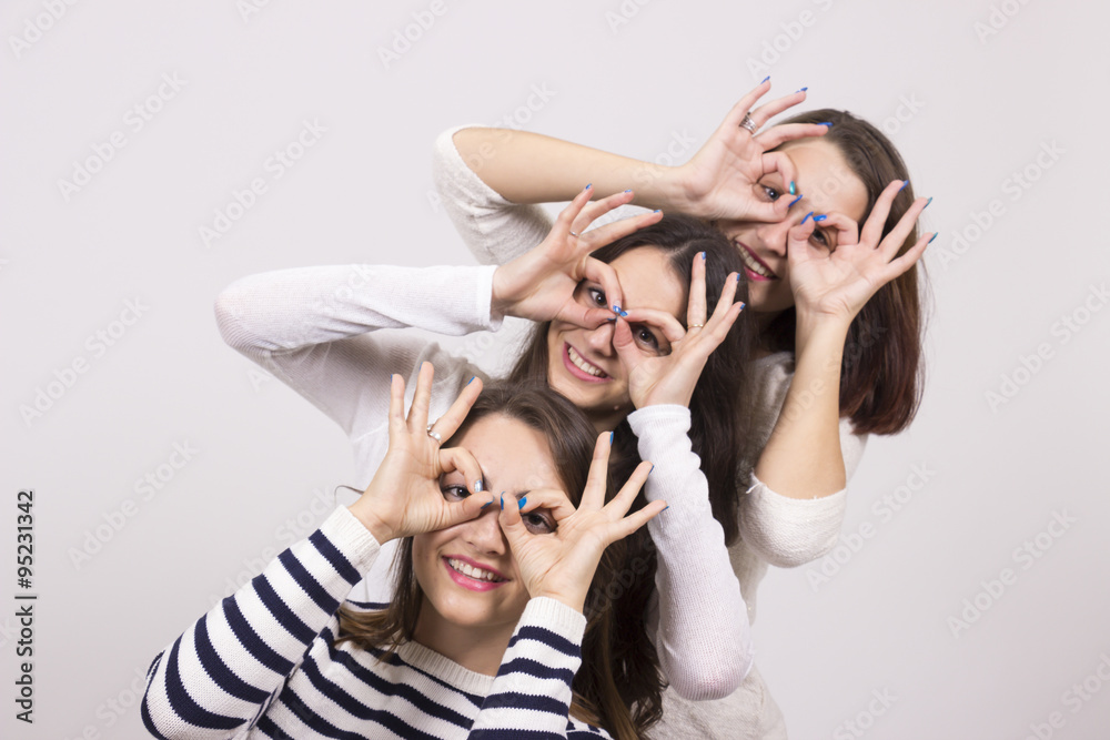 Three girls, looking trought theirs hands circle, as eyewear. Three girls, looking trought theirs hands circle, as eyewear.