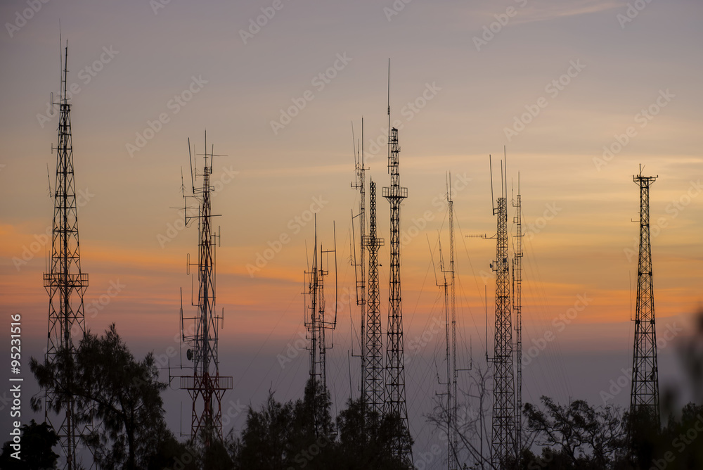 Telecommunications tower at sunrise and blue sky.