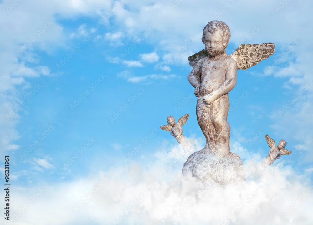 Statue of cupid/Old and dirty statue of cupid standing on blue sky, digital retouch. Statue of cupid/Old and dirty statue of cupid standing on blue sky, digital retouch.