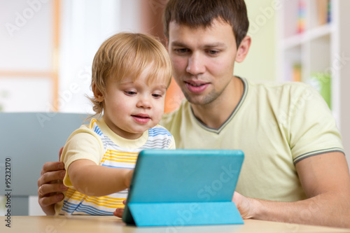 father and son kid playing ...