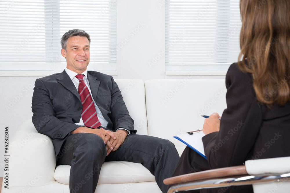 Patient On Couch In Front Of Female Psychiatrist Patient On Couch In Front Of Female Psychiatrist