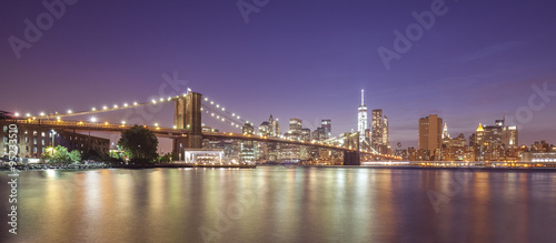 Brooklyn Bridge and Manhattan waterfront at night, NYC, USA.