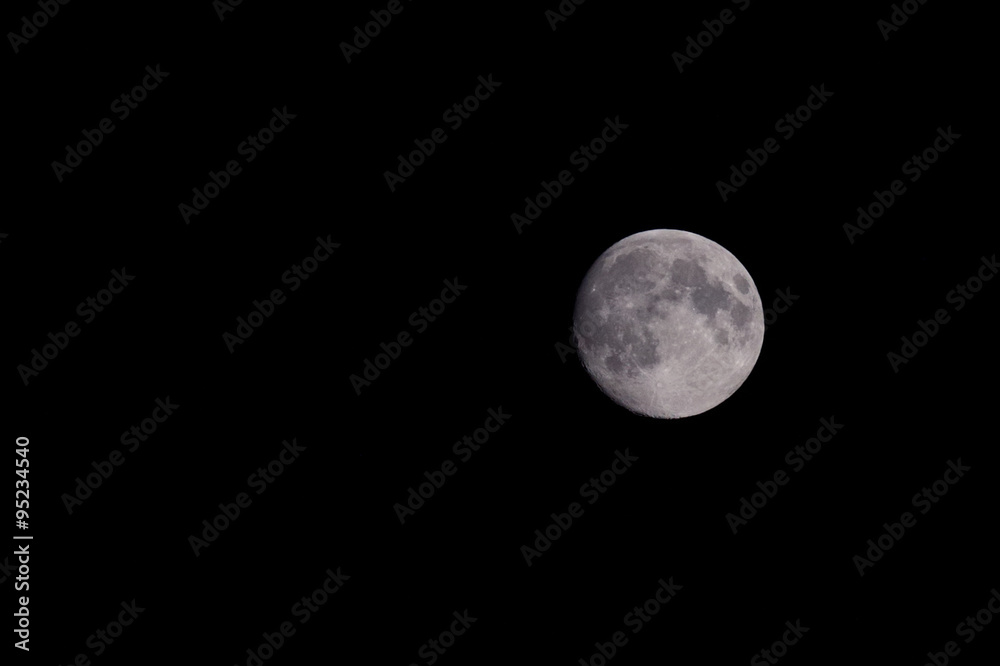 Closeup of beautiful silver full moon over dark black sky Closeup of beautiful silver full moon over dark black sky