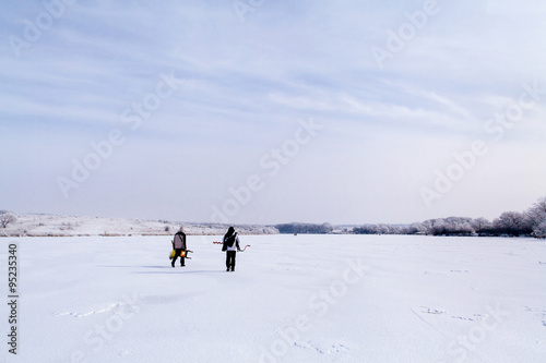 winter fisherman on frozen lake