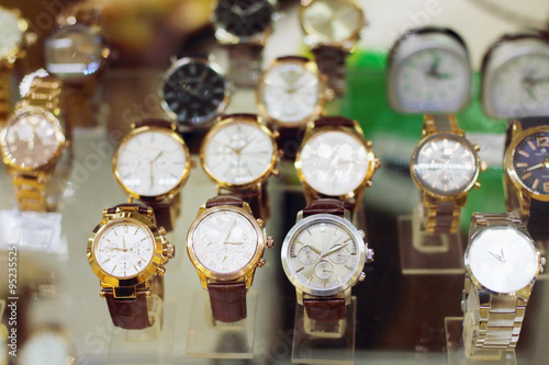 New stylish modern wristwatches in glass showcase 