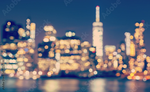Photography Vintage toned blurred Manhattan waterfront at night, NYC, USA.