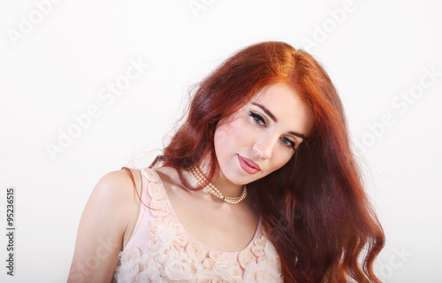 Portrait beautiful young smiling girl with red long hair