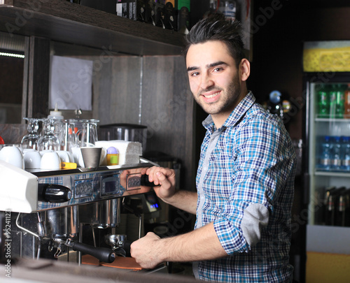 Fototapeta Naklejka Na Ścianę i Meble -  Professional expert barista makes coffee with a coffe machine