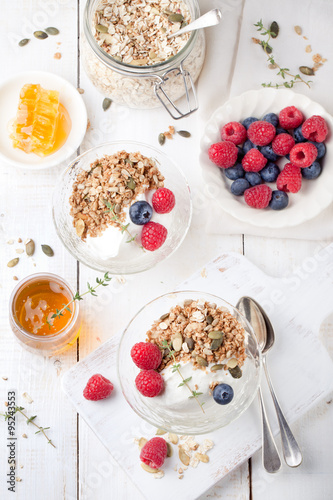 Healthy breakfast. Granola with pumpkin seeds, honey, yogurt, fresh berries .