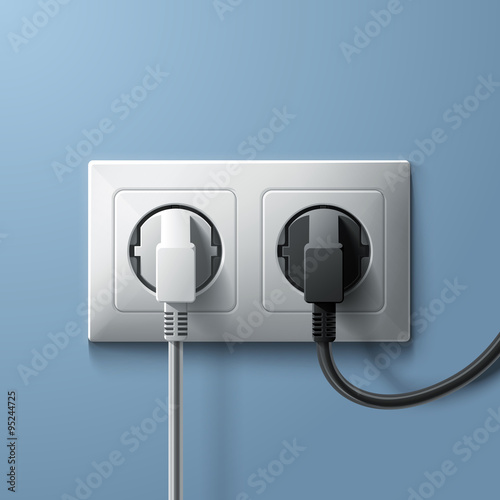 Electric white and black plugs with plastic socket on blue wall background