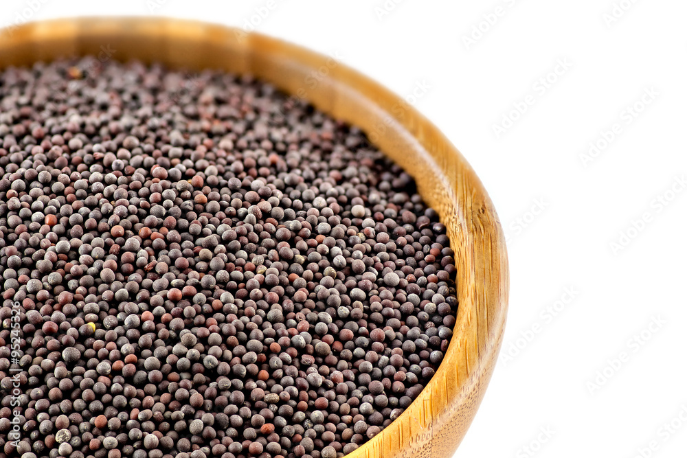 Isolated closeup of black mustard seeds in bowl Isolated closeup of black mustard seeds in bowl