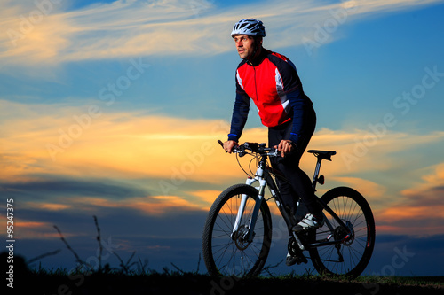 young adult cyclist riding mountain bike in the countryside