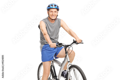 Senior with a blue helmet posing on a bicycle © Ljupco Smokovski