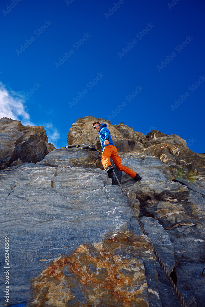 climber climbing up a cliff