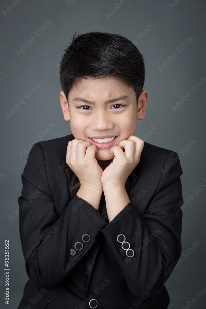 Little asian boy in black suit upset, depression face Little asian boy in black suit upset, depression face