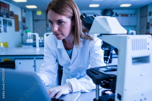 Scientist working with a laptop in laboratory