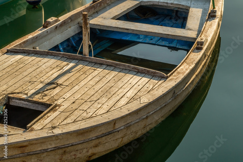 Wooden retro boat almost full of seawater and lonely stands afloat. 