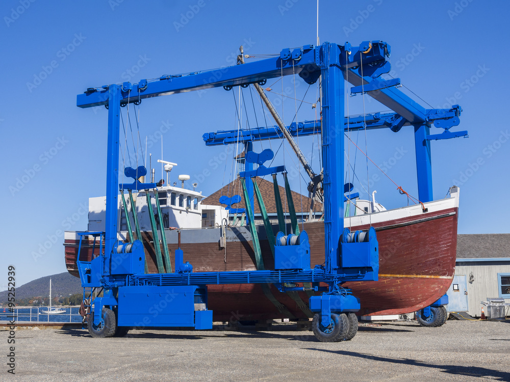 Fishing boat being rolled into drydock for repairs