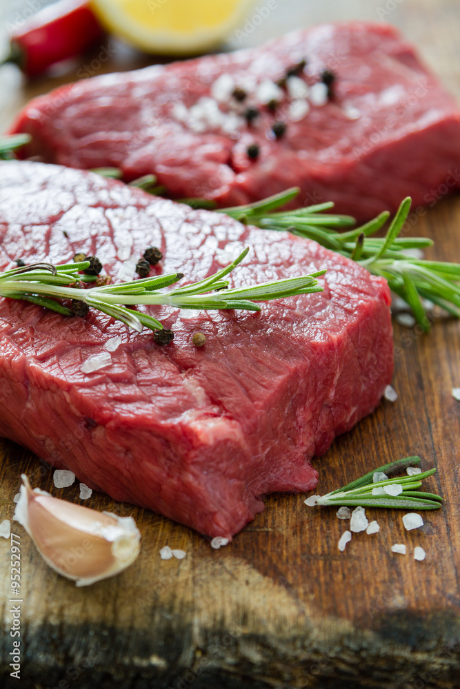 Raw meat on wood background