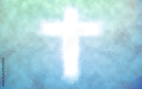 abstract blurred christ cross over green blue color background with bokeh circle lights:blur religious backdrop concept:blurry power of religion conceptual. © ammij