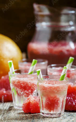 Cocktail with vodka, soda and grapefruit with striped straws, se