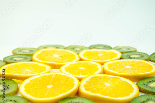 Fototapeta Naklejka Na Ścianę i Meble -  Orange, kiwi thinly sliced