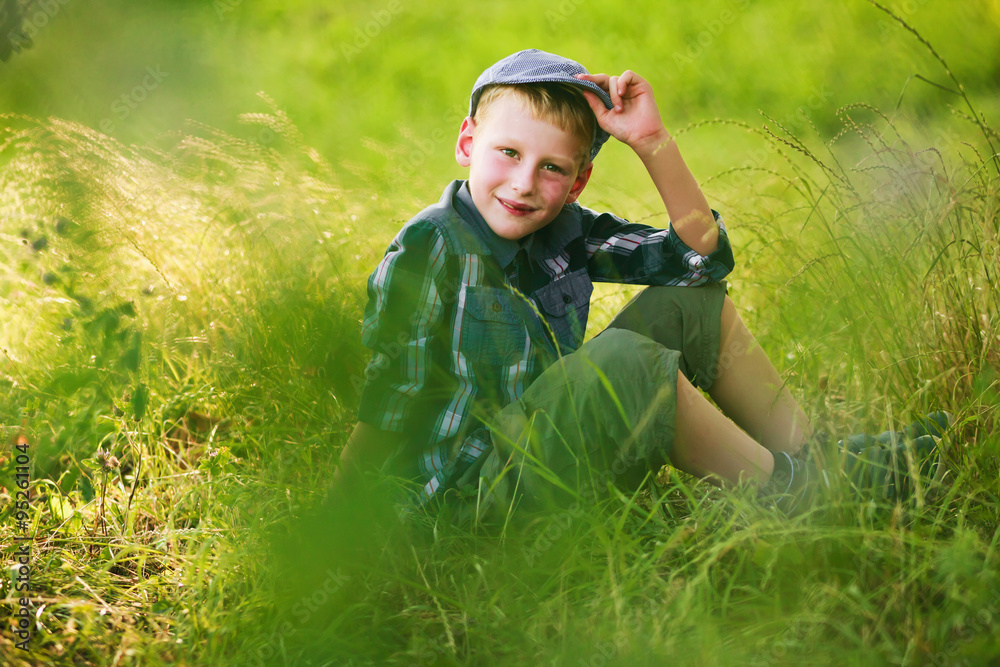 7-years boy in retro cap outdoors portrait .