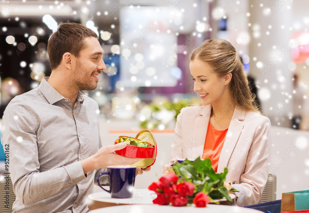 happy couple with present and flowers in mall happy couple with present and flowers in mall
