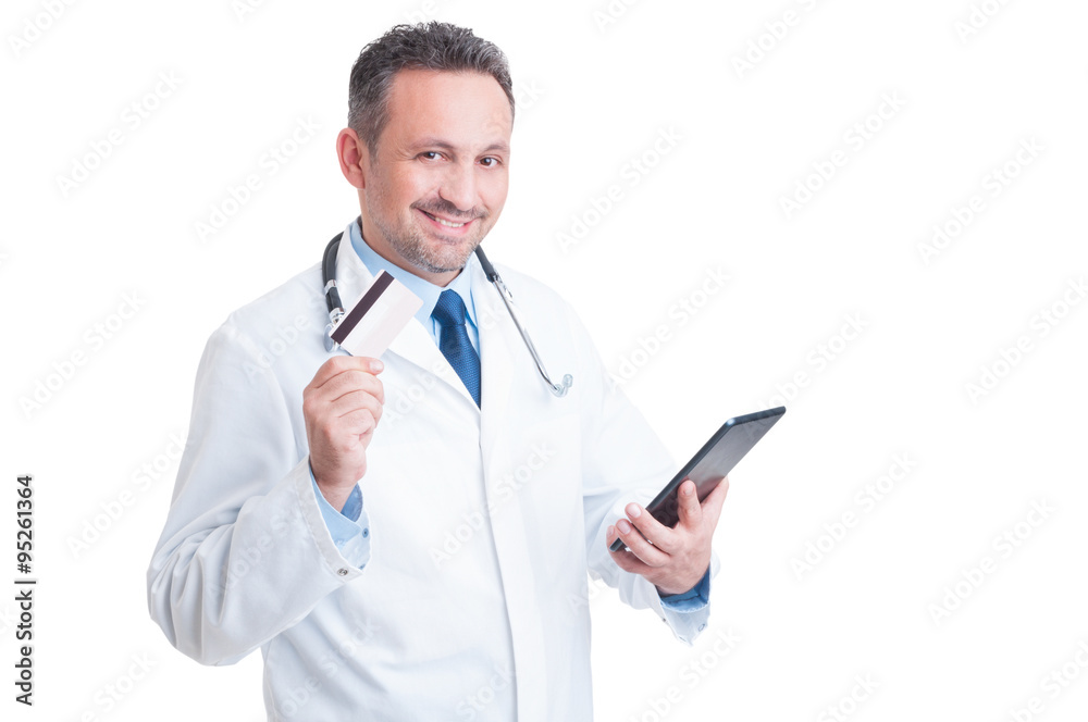 Doctor or medic holding credit card and wireless tablet Doctor or medic holding credit card and wireless tablet