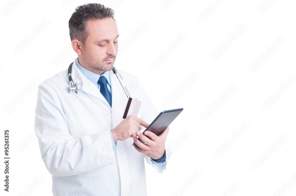 Doctor or medic using credit card and wireless tablet Doctor or medic using credit card and wireless tablet