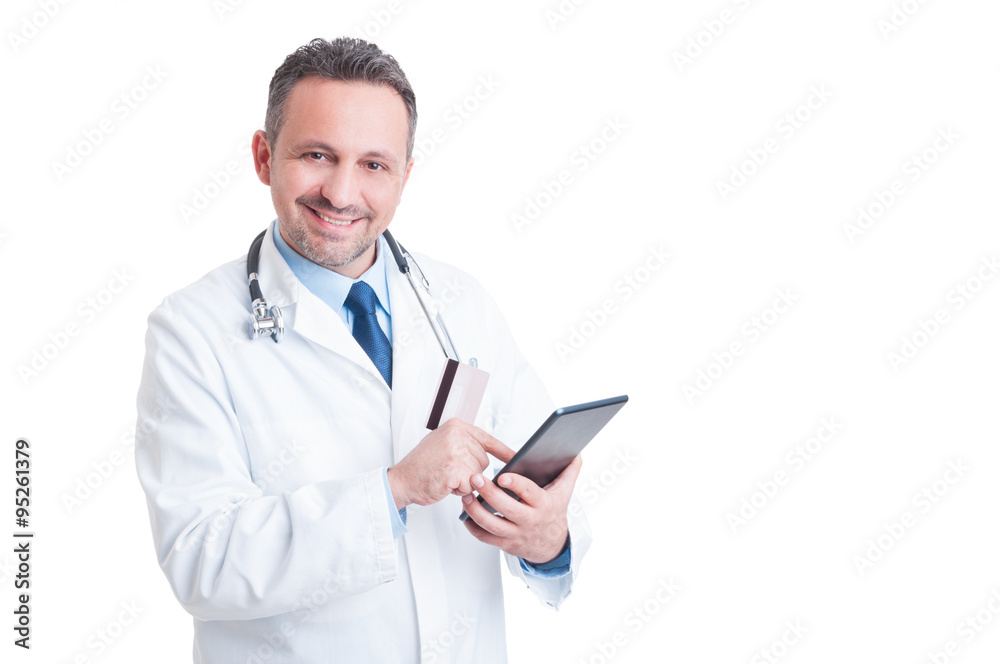Smiling doctor or medic using credit card and wireless tablet Smiling doctor or medic using credit card and wireless tablet