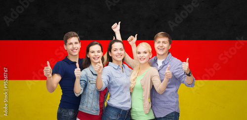 group of smiling students showing thumbs up