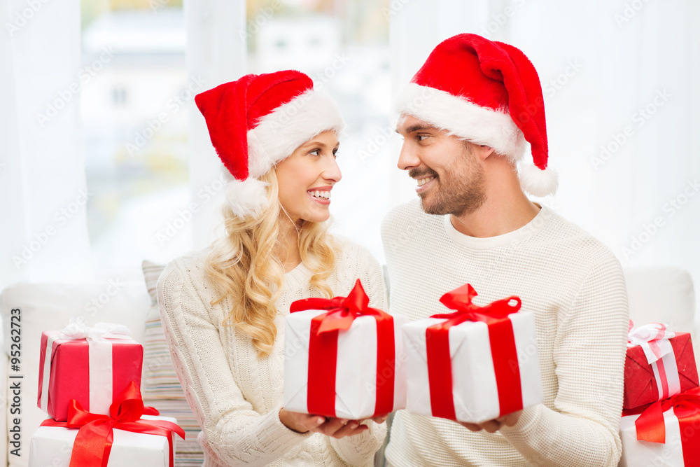 happy couple at home exchanging christmas gifts
