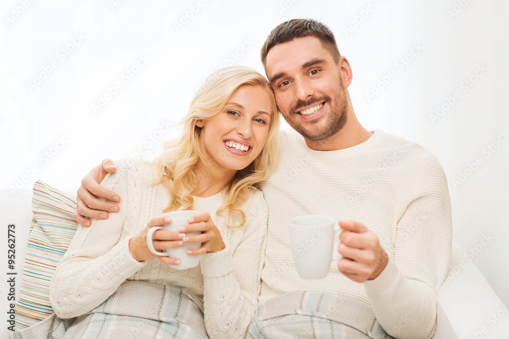 happy couple with cups drinking tea at home happy couple with cups drinking tea at home
