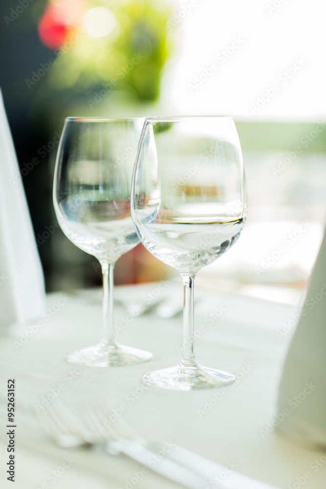 close up of two wine glasses on restaurant table close up of two wine glasses on restaurant table