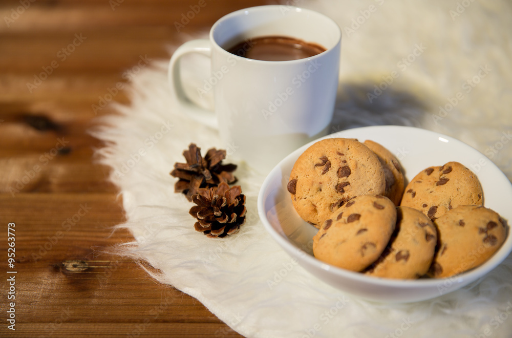 cups of hot chocolate with cookies on fur rug cups of hot chocolate with cookies on fur rug