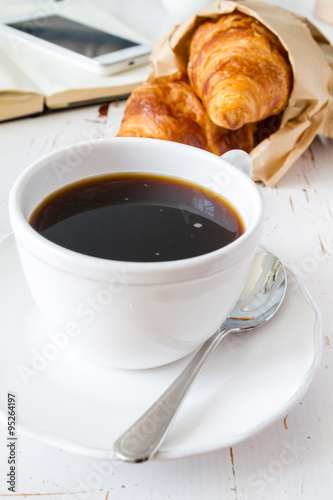 Coffee, croissants in paper bag