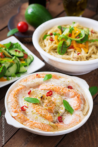 Baked slices of red and white fish with honey and lime juice  served with fresh salad and soft noodles in miso broth. 