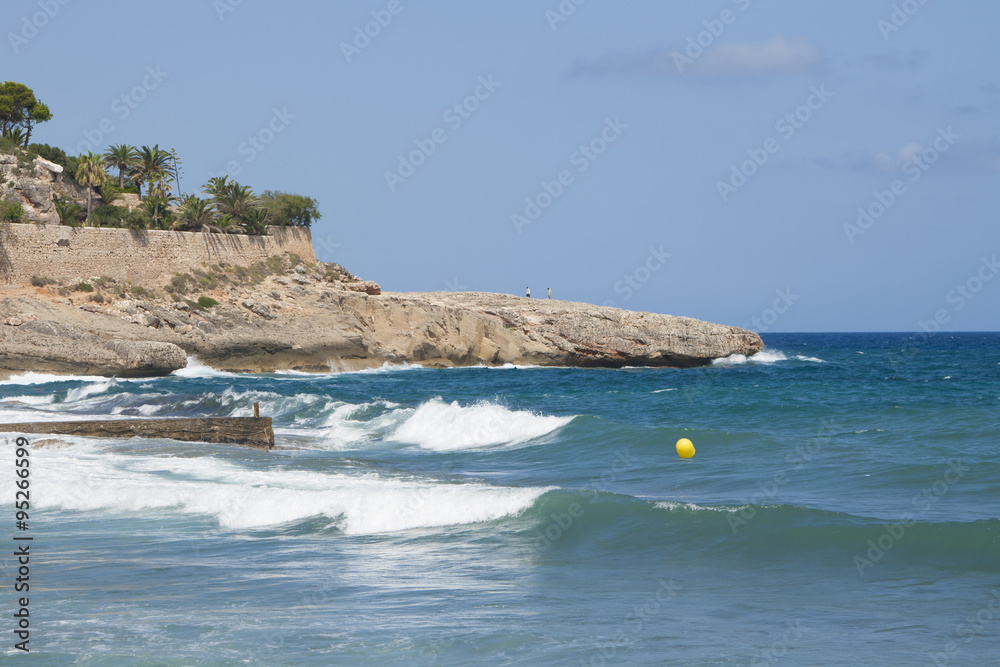Waves, rocks and palms in Cala Murada, south-eastern Mallorca, Spain Waves, rocks and palms in Cala Murada, south-eastern Mallorca, Spain