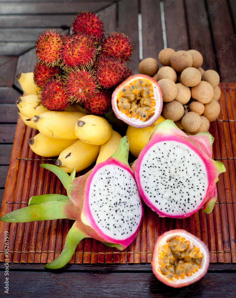 Assortment of tropical exotic fruits: dragonfruit, bananas, passion , longan, rambutan 
