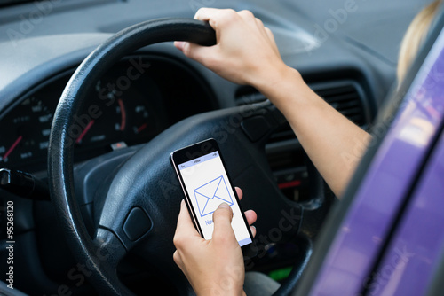Hands Checking Message While Driving Car