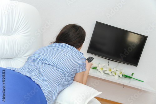 Young pretty woman enjoy watching tv
