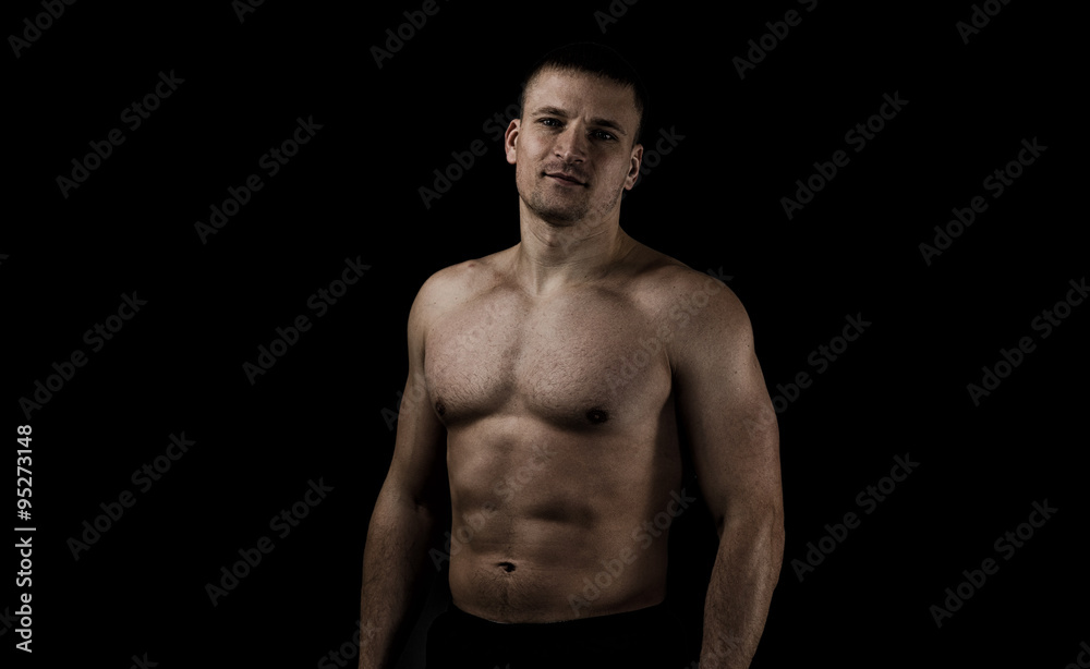 The young athlete on black background