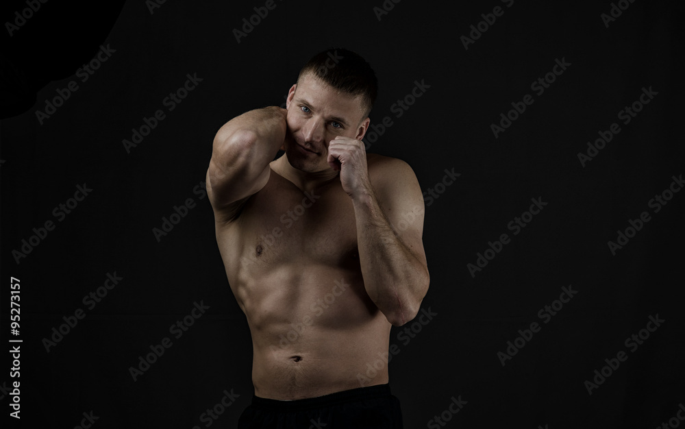 The young athlete on black background The young athlete on black background