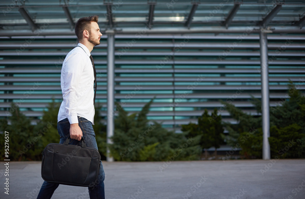 Detail of a businessman holding a briefcase Detail of a businessman holding a briefcase