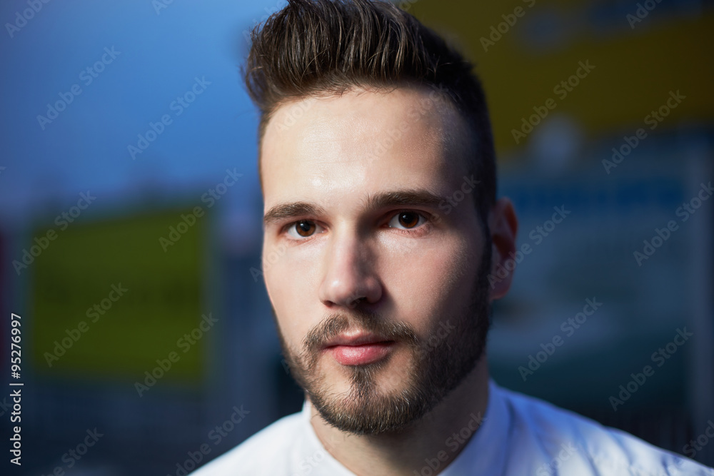 Businessman in front of business building smiling and looking co Businessman in front of business building smiling and looking co