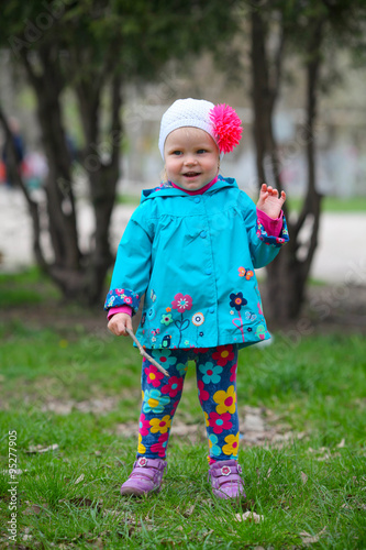 An outdoor portrait of a happy little girl on the park