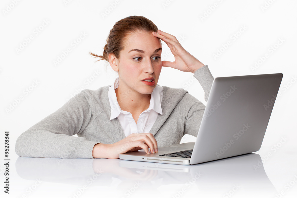 anxious 20s female student writing on laptop in white office anxious 20s female student writing on laptop in white office