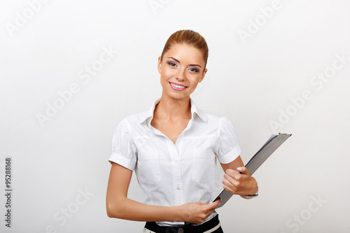 Portrait of an attractive young businesswoman with folder isolated on white